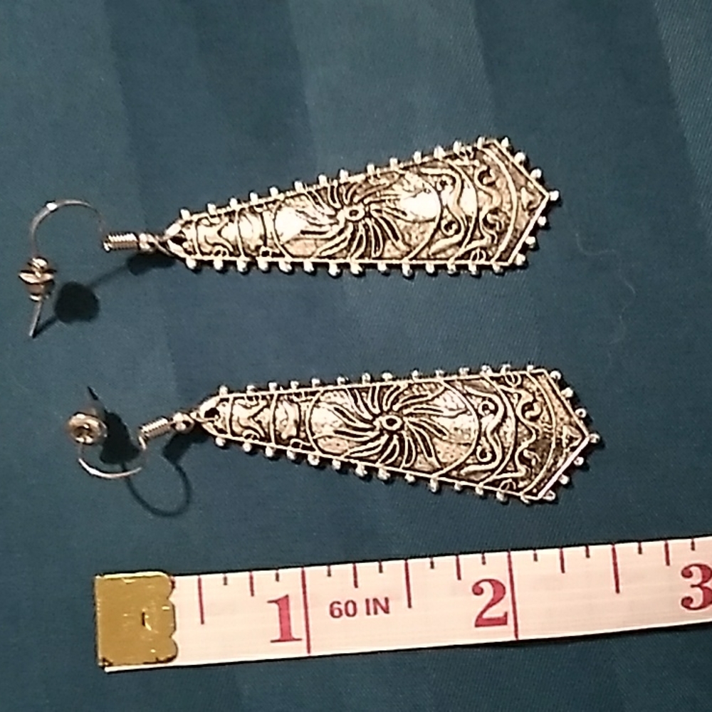 Silver metal triangular shaped earrings with etched designs